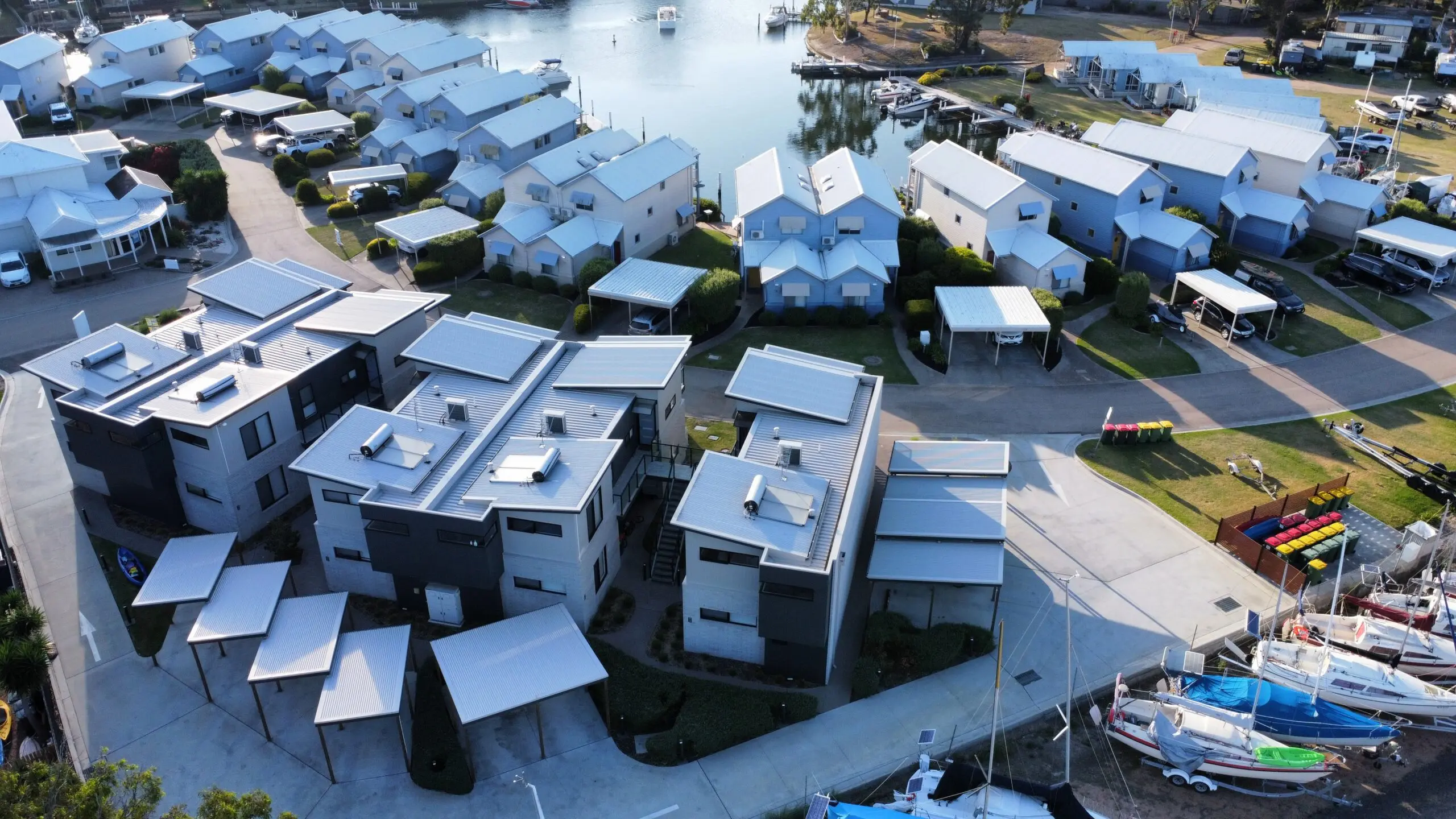 Drone view showing layout of Captains Cove Resort, including parking, apartment buildings, and access pathways.